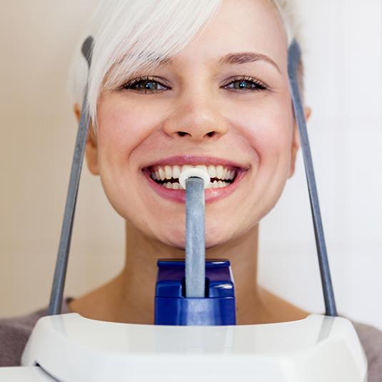 woman smiling in x-ray machine