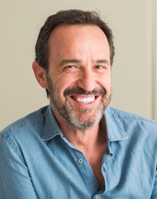 a man smiling with a dental bridge in Cherry Hill