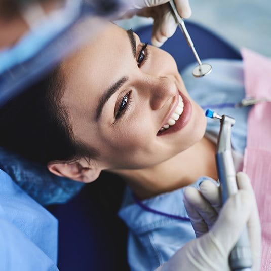 woman getting dental cleaning