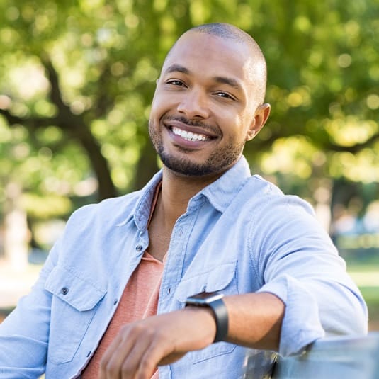 man sitting on bench outside