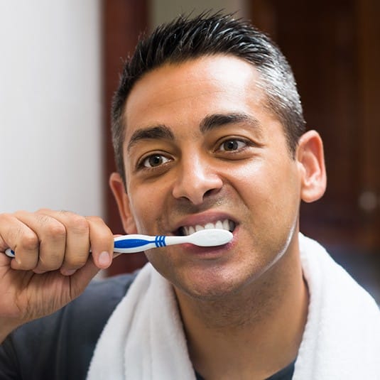 man brushing teeth