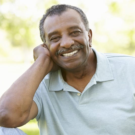 man leaning on arm smiling