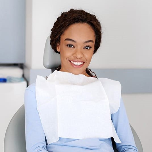 patient smiling while at her dentist’s office