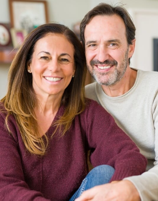 couple with dental implants in Cherry Hill showing off their smiles 