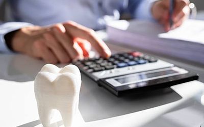person typing on a calculator