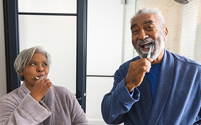 Couple brushing teeth together in bathroom