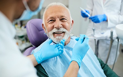 Man smiling at dentist during exam