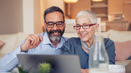 man and woman looking at laptop