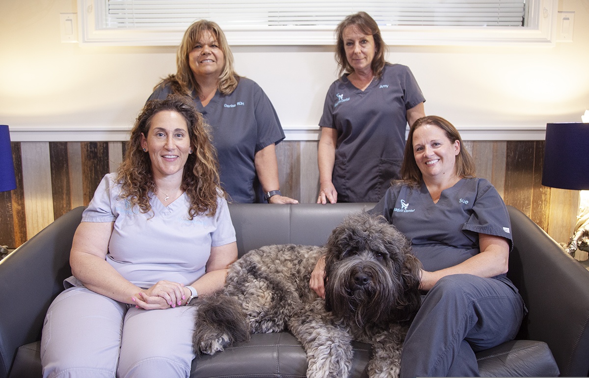 Cherry Hill team on couch with Ludo