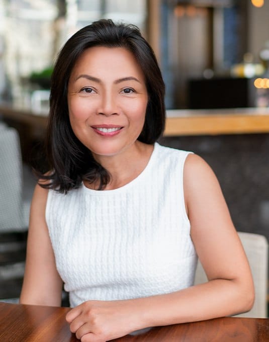 woman in white dress smiling