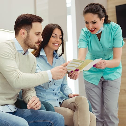 team member going over paperwork with couple