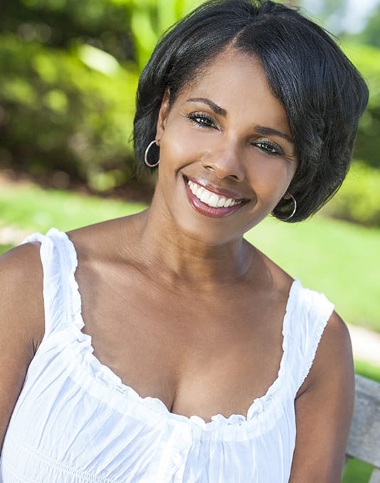 woman wearing white shirt smiling