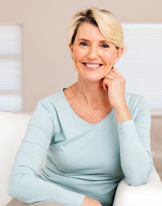 woman in light blue shirt smiling