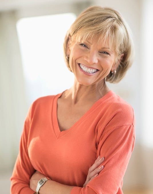 woman in orange shirt smiling