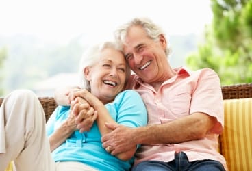 husband and wife hugging and laughing