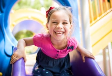 young girl on purple slide