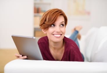 woman holding a tablet smiling