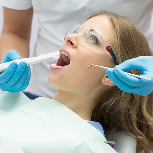 dentist using intraoral camera on woman