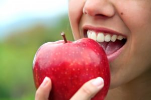 person about to eat apple