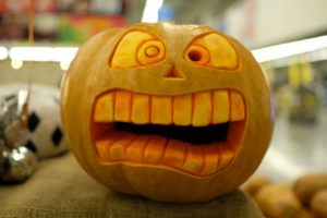 scared face carved into orange pumpkin 