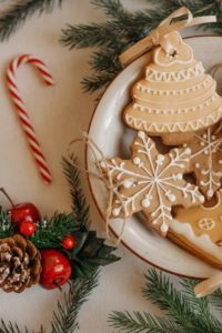 Cookies and candy cane on holiday table