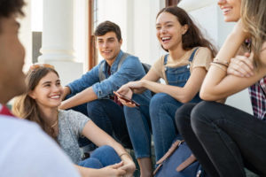 Group of happy teenagers socializing 