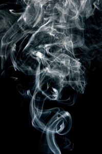 Cigarette smoke and black background