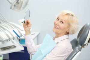 closeup of woman smiling after getting dentures 